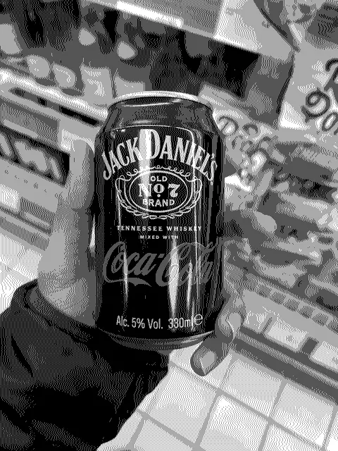 A guy holding a can of Jack Daniels Cola after dithering